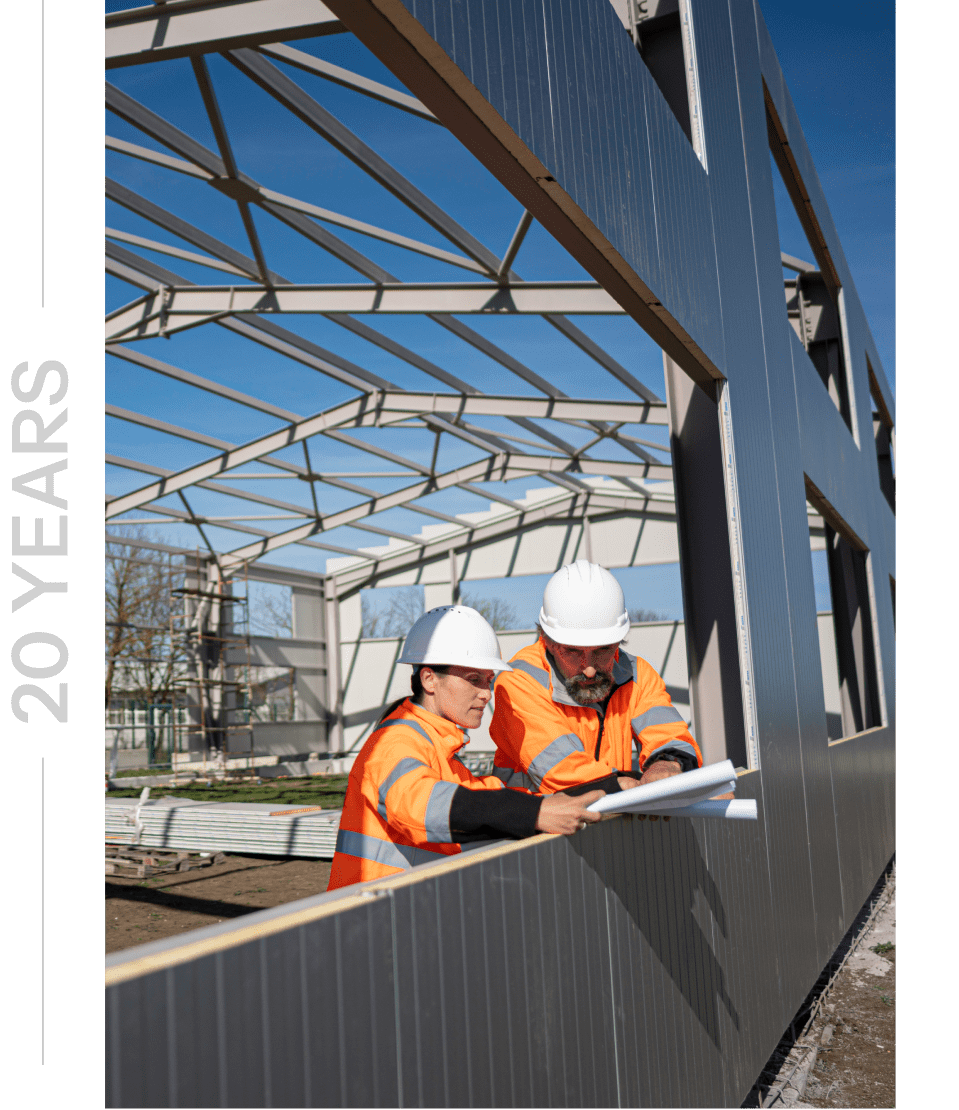 Construction workers reviewing plans on site.